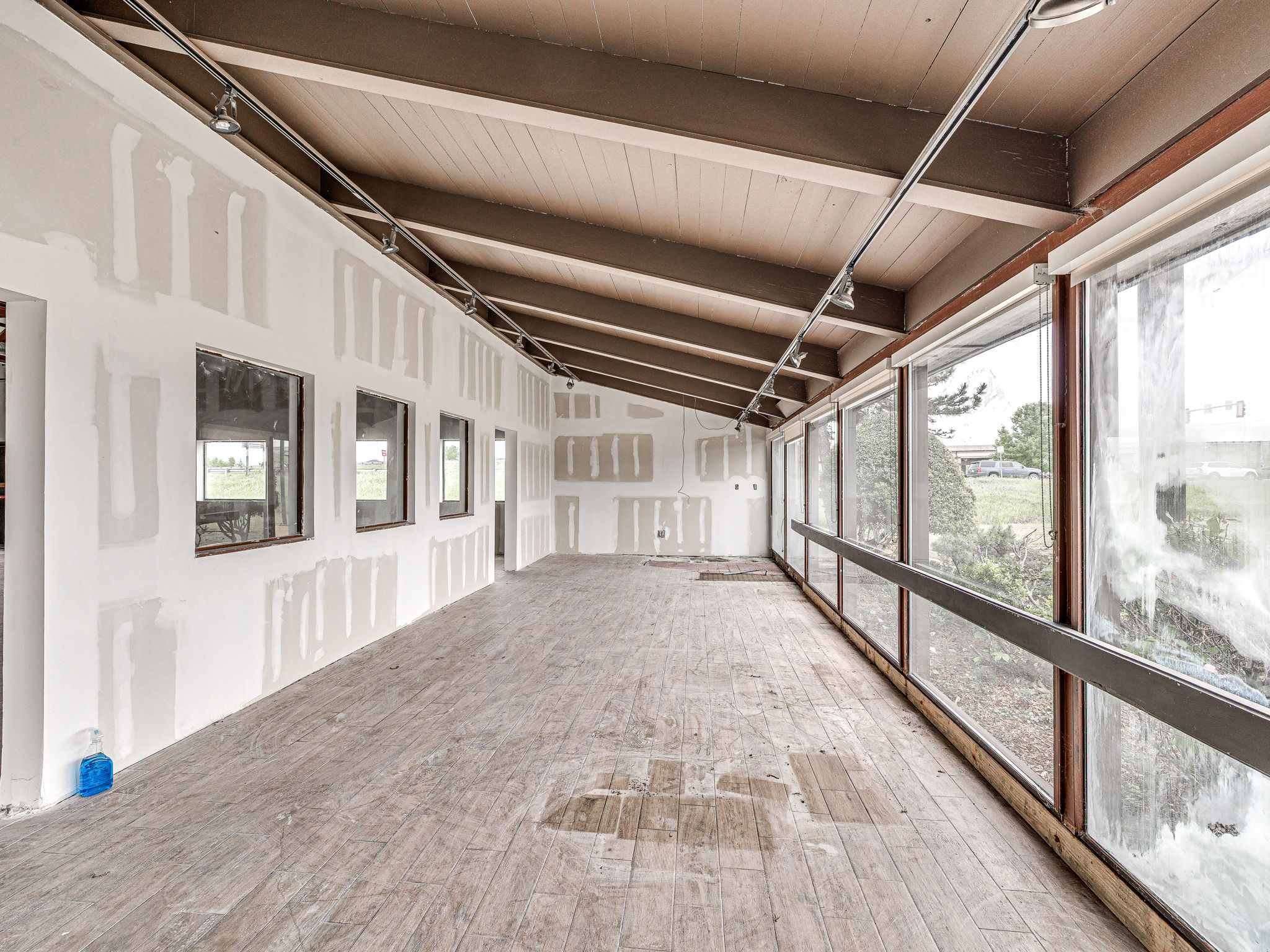 Enclosed glass patio with a wall of windows facing the interchange